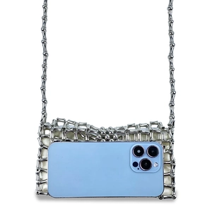 Silver metal woven mini bag showing interior capacity with a smartphone inside