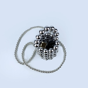 Detailed top view of a handmade silver beaded mini bucket bag with metallic pearl finish