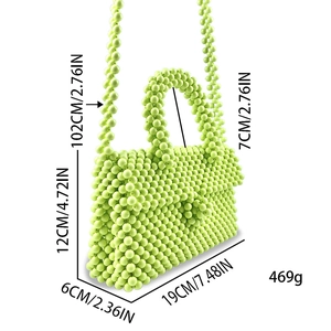 Detail view of light green hand-beaded handbag showing dimensions 19cm x 12cm x 6cm