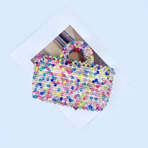 Close-up of handmade rainbow beaded bag featuring transparent colorful crystal beads