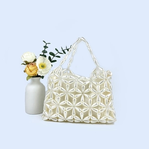 Detail of teardrop pearl weave handbag with inner satin lining and floral beadwork