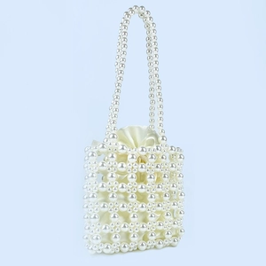 Detail of handmade pearl beaded handbag with ivory satin drawstring lining and double handles