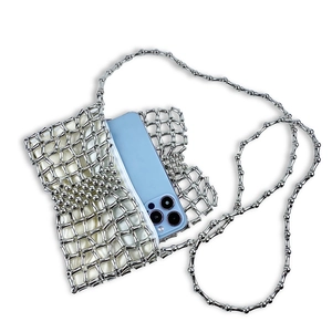 Silver hand-woven metal crossbody bag showing interior storage capacity with a smartphone