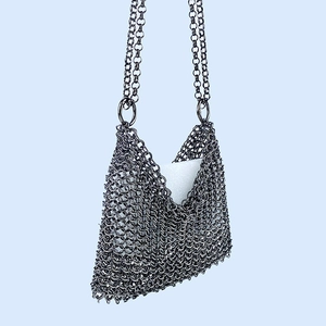 Macro shot of silver metal mesh handbag showing detailed chain link texture and design