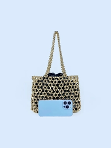 Golden handmade beaded shoulder bag with hollow design and black inner pouch
