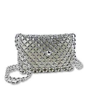 Detail of silver metallic beaded crossbody bag with intricate hollow woven design