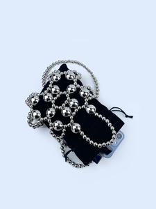 Silver beaded mini crossbody bag with black velvet lining and polished metallic finish
