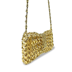 Detail of golden bamboo metal woven bag with off-white lining and zip closure