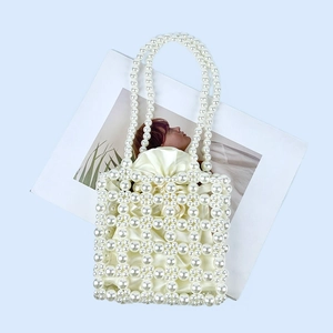 Detailed view of handmade pearl beaded handbag with cream satin drawstring lining