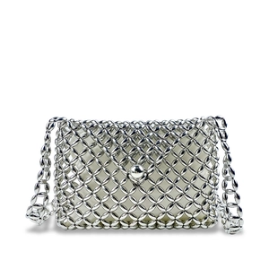Close-up of silver beaded crossbody bag with hollow weave and fabric lining