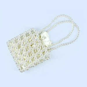 Close-up of handmade pearl beaded handbag with a satin drawstring inner bag