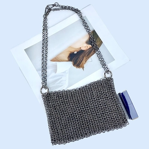 Detail of gunmetal mesh weave texture on metallic handmade crossbody bag with chain