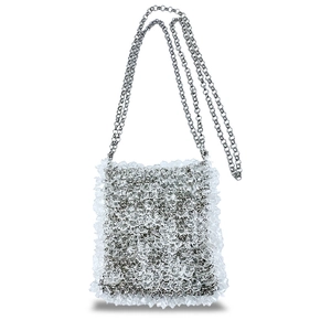 Détail de la bandoulière argentée sur un sac en perles acryliques blanches et vagues