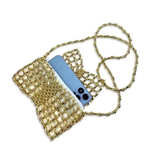 Detail view showing a smartphone inside a gold woven bead bag with white satin lining