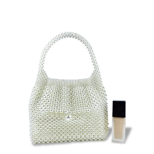 Macro shot of handmade pearl beaded handbag with trapezoid shape and integrated handle