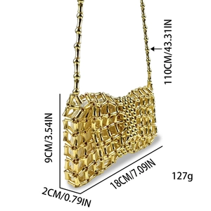 Detail of golden woven beaded handbag with bamboo-style tubes and chain strap