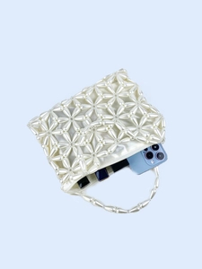 Handmade white pearl woven handbag with floral patterns and satin lining for parties