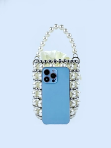 Elegant pearl beaded bucket bag with drawstring pouch showing size compared to a phone