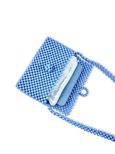 Handmade light blue beaded crossbody bag with white lining showing phone capacity