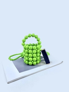 Mini green hand-woven pearl bucket bag with a crossbody chain and round handle