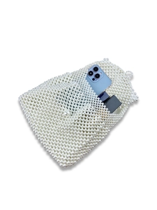 Handmade white pearl woven handbag showing storage capacity for phone and cosmetics