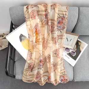 Lightweight apricot floral scarf with gold leaf print and elegant wave pattern drape