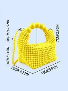 Yellow handmade beaded handbag with crossbody strap and size measurements on blue background