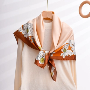Elegant 90x90cm floral silk satin square scarf with orange and brown print on a hanger