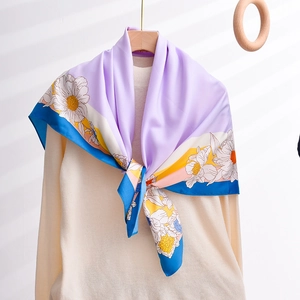Purple silk-like square scarf with white daisy floral prints hanging on a hanger
