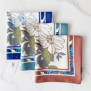 Elegant 90x90cm floral twill square scarf set in blue, teal, and brick red on marble