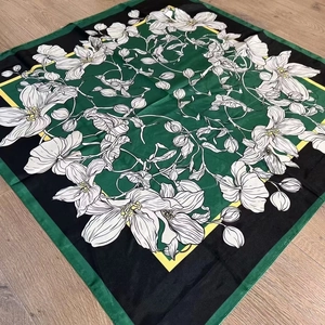 Floral print silk square scarf in deep green and black with elegant flower patterns