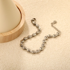 Detailed macro view of silver heart link chain bracelet with adjustable extension chain