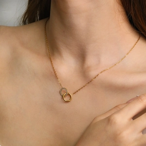 Detail of 18K gold plated double interlocking circles necklace worn by a female model
