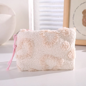 Close-up of plush leopard print makeup bag with soft fleece texture and pink zipper pull
