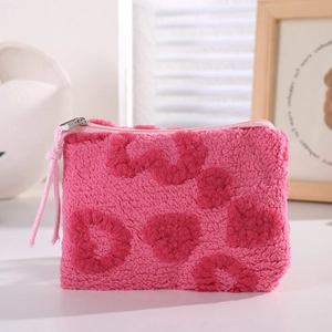 Detailed close-up of pink heart pattern plush cosmetic bag with soft teddy fleece texture
