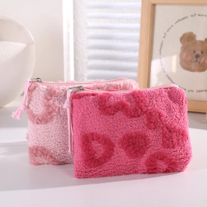 Plush heart-patterned makeup bags with pompom zipper in soft pink sherpa fleece