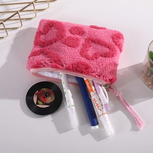 Pink plush heart makeup pouch with lambswool texture and metal zipper closure