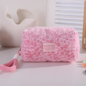 Detail view of pink leopard plush makeup bag with soft texture and sturdy top handle