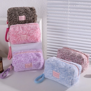 Detail of colorful leopard print plush makeup bags with soft texture and sturdy zippers