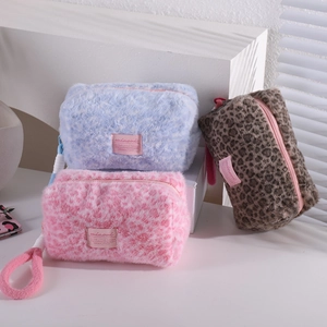 Leopard plush cosmetic bag with handle and zipper in blue, pink, and brown leopard prints