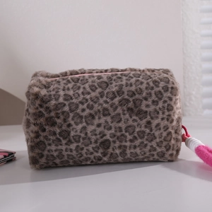 Detail of leopard print plush cosmetic bag with pink zipper and soft faux fur texture