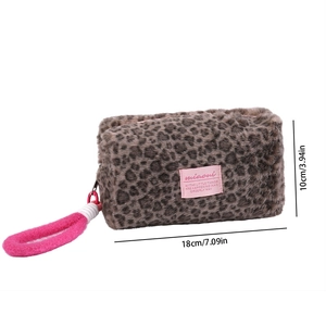 Detail view of leopard print plush cosmetic bag showing soft texture and dimensions