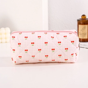 Detail of pink checkered quilted pencil case with red cherry print and zipper closure
