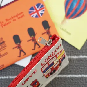 Close-up of durable Oxford fabric pencil case with red metal zipper and London icons