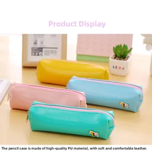 Detail of four colorful PU leather pencil cases with horse-shaped enamel charms on desk