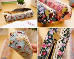 Detail of floral canvas pencil case with lace trim and vintage heart zipper puller