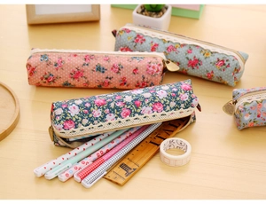 Detail of floral canvas pencil case with retro metal zipper and white lace trim