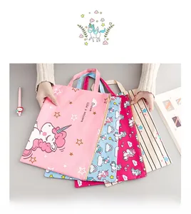 Detail of four colorful canvas A4 unicorn document bags with handles and zip closures