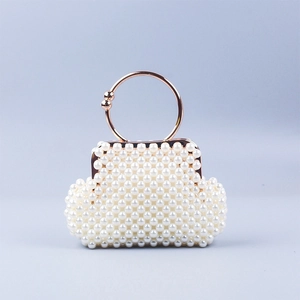 Detail of handmade beaded shell bag with rose gold circular handle and pearl weaving