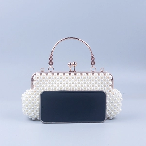 Detail of pearl evening clutch with metal handle showing smartphone size comparison